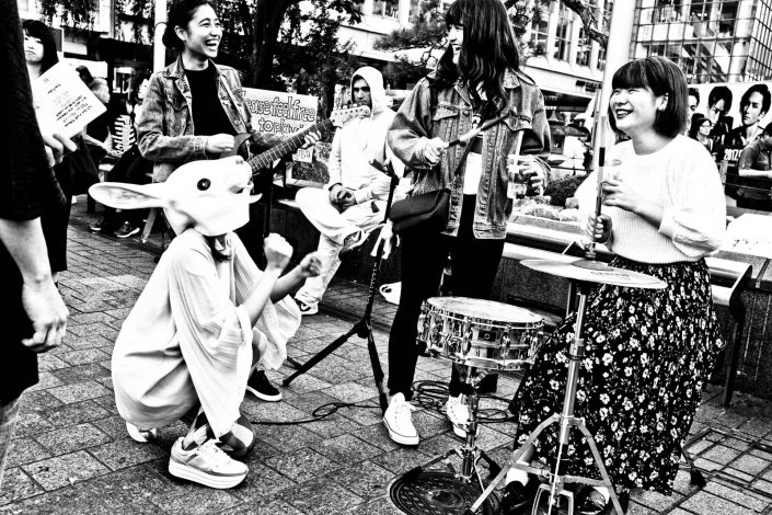 Happy Shibuya rockband with drums,gituar, smiles and a rabbit. Street Photography by Victor Borst