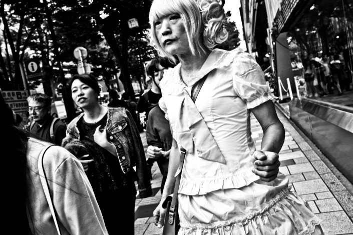 Old Japanese crossdresser Lolita with a dress and wig at Harajuku. Street Photography by Victor Borst