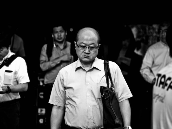 Bald men with glasses at Shimbashi station of to work. Street Photography by Victor Borst
