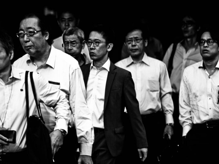 Big group of salarymen at Shimbashi station. Nobody looks into the camera. Street Photography by Victor Borst