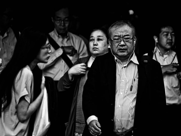 Group of salarymen and women at Shimbashi station, Tokyo. Street Photography by Victor Borst