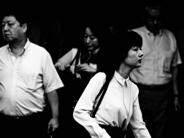Shimbashi Blues in the morning with a woman not looking in the camera. Street Photography by Victor Borst