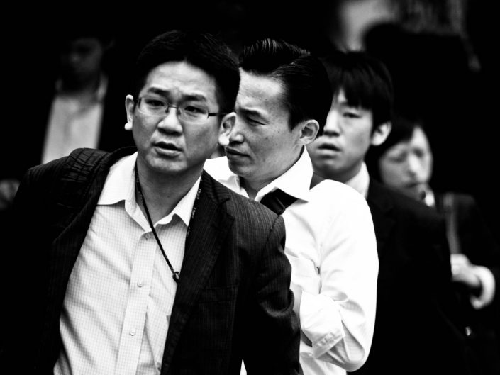 Four faces in a row at Shimbashi station. Street Photography by Victor Borst