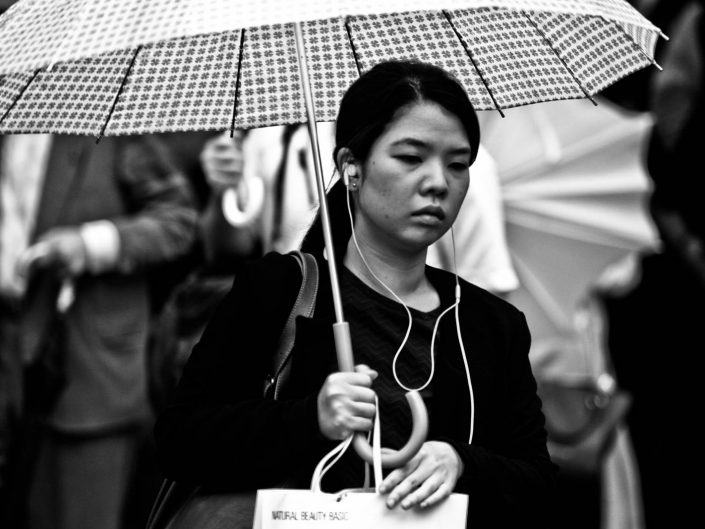 Portrait of a Japanese women with umbrella at shimbashi station. Street Photography by Victor Borst