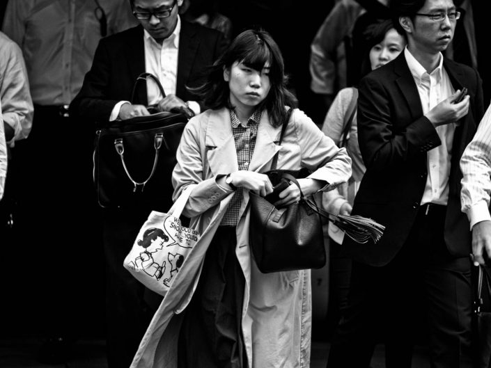 Salarywomen with snoopy bag heading to work at Shimbashi Station. Street Photography by Victor Borst