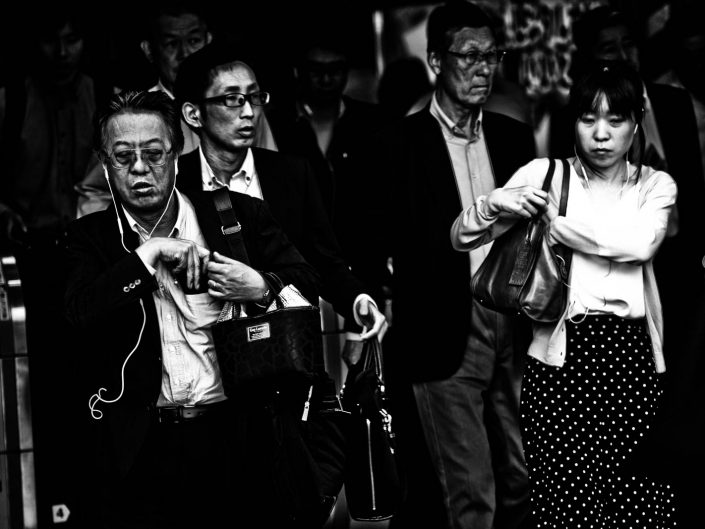 Four Salarymen and women at Shimbashi Station. Street Photography by Victor Borst